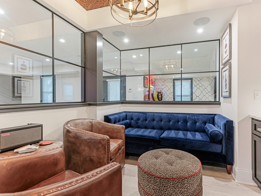 Living room with a coffered ceiling, built-in cabinetry, and sliding doors to the yard