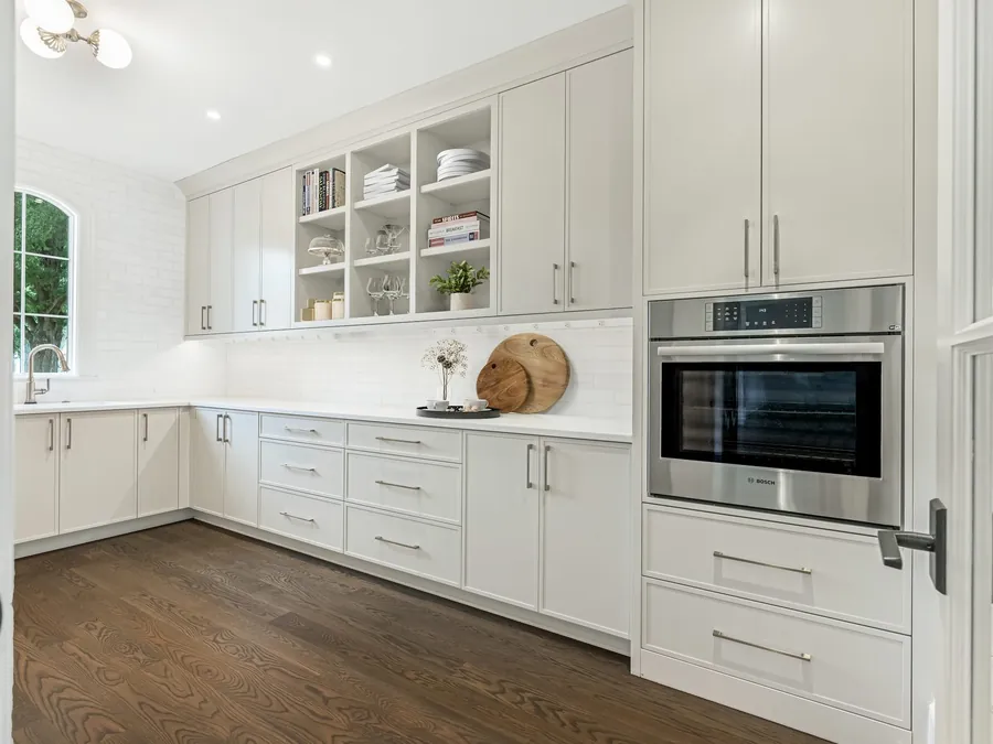 Custom white cabinetry and a built-in wall oven in Waldon's renovated kitchen