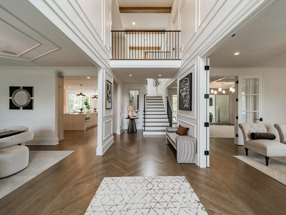 The rebuilt Waldon foyer, open to a two-story stair hall with herringbone oak floors